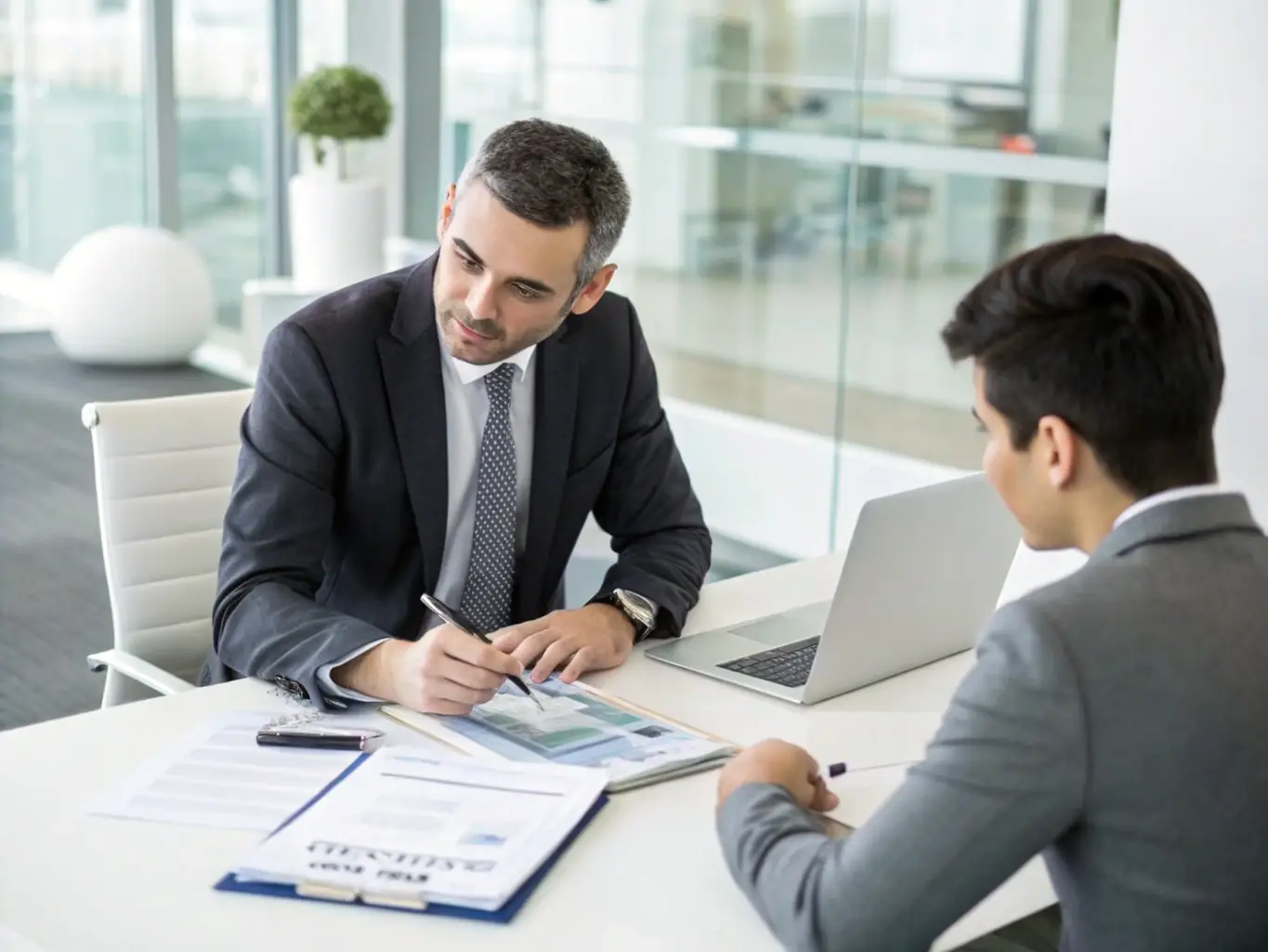 An image of a financial advisor reviewing tax documents with a client in a modern office setting, emphasizing tax planning services.